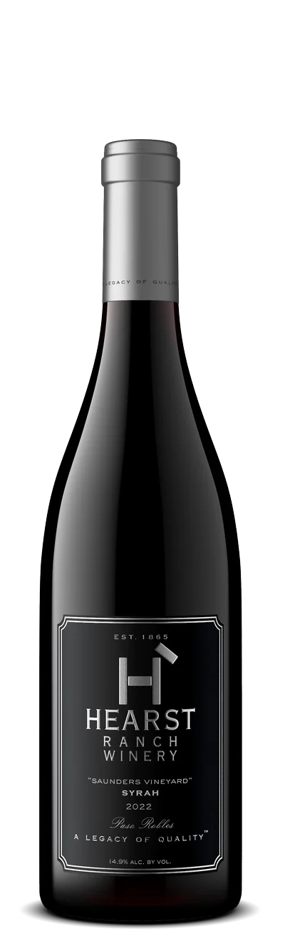 A bottle of Hearst Ranch Winery Syrah 2022 "Saunders Vineyard" with a black and silver label, featuring winery branding and wine details. TheCentralCoast.com